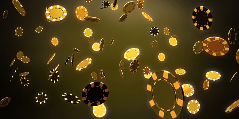 Falling poker chips on a black background