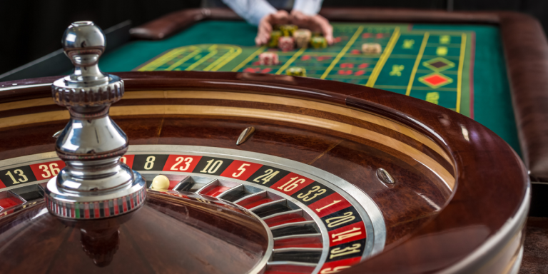 Roulette wheel and board with a dealer's hands