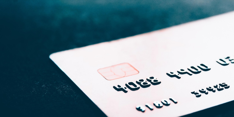 A payment card close up against a blue backround