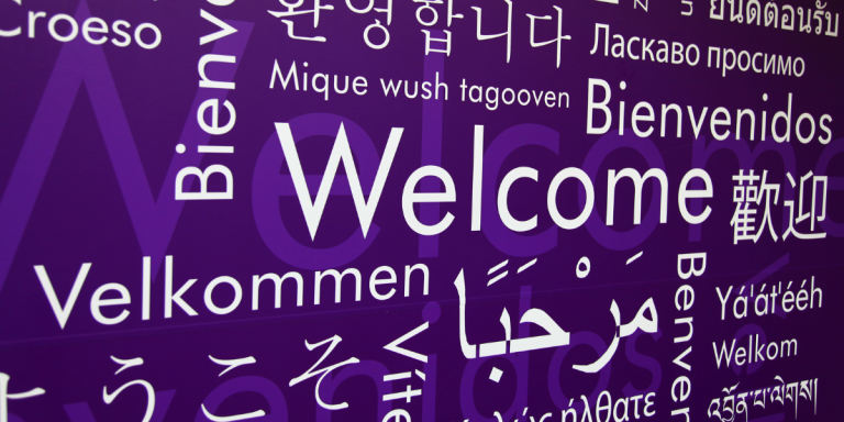 "welcome" written in different languages against a blue background